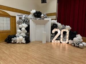 Elegant black, white, and silver balloon backdrop with light-up "20" for Gabriel’s 20th birthday by Iconic Events Edmonton. Making Every Event in Edmonton Iconic.